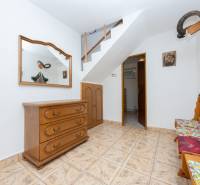 A bright hallway in a family house with wooden furniture, a mirror, and hunting decorations.