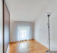 A room in a family house with a wooden decor floor and a cabinet.