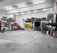 Workshop with tools and stairs in a family house. Ceilings with lighting and concrete floor.