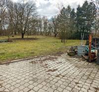Pavlice, a family house in Pavlice with a paved courtyard, a shed, and a pile of tires.