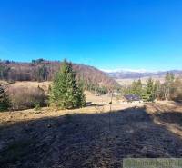 Agricultural and forest land in Hronec with picturesque views of the surrounding hills.