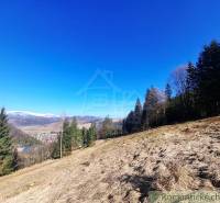 A hilly landscape of agricultural and forest lands around the village of Hronec with a winter panorama.