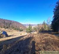The landscape in the village of Hronec, agricultural and forest lands with views of the mountains and houses.