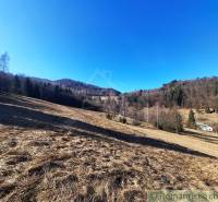 Hilly landscape with forests and meadows around Hronec on agricultural and forest lands.