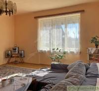 Living room in a family house with a sofa, carpets, and a hi-fi set.