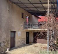 A family house in Bretka with a balcony, a garage, and a pergola for climbing plants.