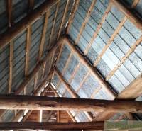 Roof structure of the interior in a family house with wooden beams and metal roofing.