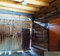 Interior of a wooden family house with a wooden gate and lighting.