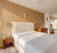 Bright bedroom with a bed and decorative animal motif in a 3-room apartment.