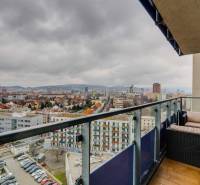 View from the balcony of a 3-room apartment on Plynárenská Street in Bratislava with garden furniture.