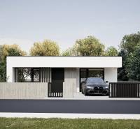 A family house in Nesvady with a concrete fence and a garage next to a green environment.