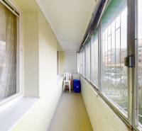 A comfortable loggia in a 2-room apartment with a view of the housing estate and parking lot.