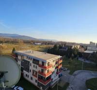 View from a studio apartment in Topoľčany of the surroundings with apartment buildings and nature.