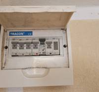 Electrical switchboard with circuit breakers in a studio apartment, mounted on the wall with a cover.