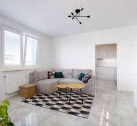 Living room with a corner sofa, dining table, and balcony in a 3-room apartment.