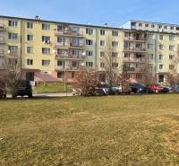 A block of flats on Prachatická Street in Zvolen, in front of which cars are parked.