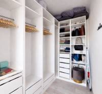 A wardrobe with shelves and hangers in a 3-room apartment, elegant arrangement of clothing.