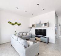 Living room in a 3-room apartment with modern furniture and a television, decoration on the wall.