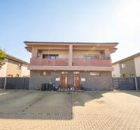 The exterior of a residential building on Lipová Street in Veľký Biel with a paved courtyard.