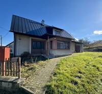 A family house in Šarišské Čierne with a lawn, a sloped roof, and a garden.