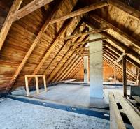 The attic of a family house with wooden beams and wooden walls.