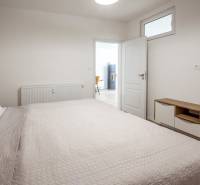 A bedroom in a holiday apartment with a comfortable bed and furniture with a wood decor.