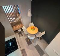Kitchen corner in a 2-room apartment with a dining table and chairs.