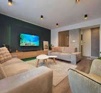 Living room in a two-room apartment with a wooden decor floor and comfortable sofas.