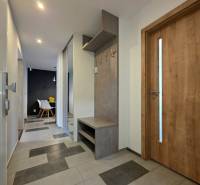 Entrance hall in a 2-room apartment with a ceramic floor and a coat rack wall.