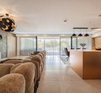 The interior of a family house with a geometric chandelier and a comfortable sofa set.
