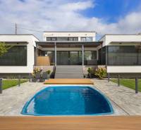 A family house in Dolný Kalník with a swimming pool, lawn, and a terrace with a pergola.
