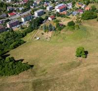 Aerial view of plots - housing in Banská Belá, surrounded by greenery and a housing estate.