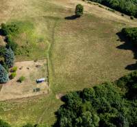 Aerial view of the green landscape and residential plots in Banská Belá.