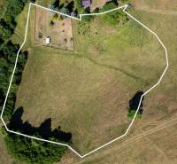 Aerial view of residential land surrounded by greenery in Banská Belá.