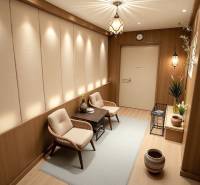 Interior of a family house with light flowers, comfortable armchairs, and a wooden decor floor.