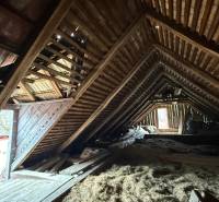 The attic of a family house with wooden beams and roofing in Babiná.