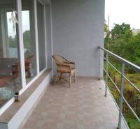 Terrace of a family house in Bystrička with glass walls and a panoramic view.