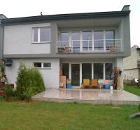A family house in Bystrička, a terrace with seating, large windows, and a manicured lawn.