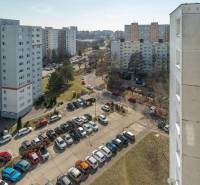 A view of apartment buildings and a parking lot on Ševčenkova Street in Bratislava - Petržalka.