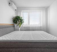 A bedroom with air conditioning and a bed in a 4-room apartment.