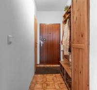 Entrance hallway in a 4-room apartment with wooden furniture and tiled floor.