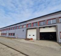 Warehouses and halls on Východná Street in Poprad, a gray building with red windows.