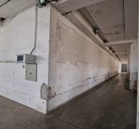 Industrial interior of warehouses and halls with concrete walls and lighting.