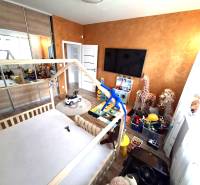 Children's room in a family house with toys, a bed, and cabinets. Floor with wooden decor.