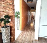 Interior of a family house with a decorative wall, wood-patterned flooring, and modern accessories.