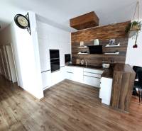 A kitchen in a family house with a wooden decor floor and modern kitchen equipment.
