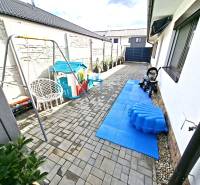 The yard at the family house on Mládežnícka Street in Galanta with a children's playground and a swing.