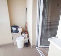 Balcony with storage needs in a 3-room apartment, tiles and glass doors.