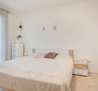 A bright bedroom with a built-in wardrobe and decorative elements in a 3-room apartment.