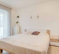 A bright bedroom in a 3-room apartment with white furniture and a bed.